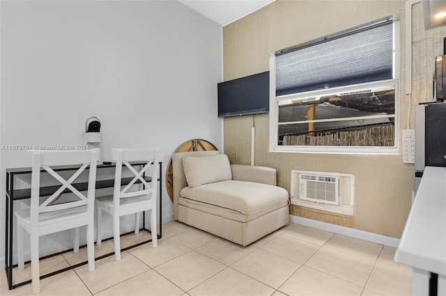 living area with an AC wall unit and tile patterned floors