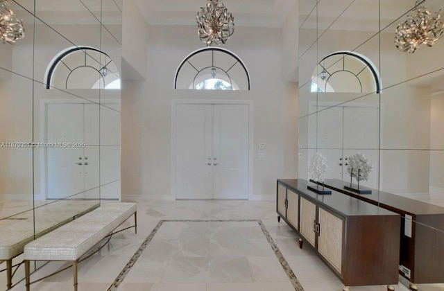 entrance foyer with a towering ceiling and a chandelier