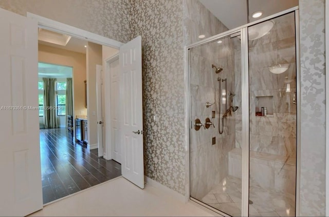 bathroom featuring hardwood / wood-style floors and an enclosed shower