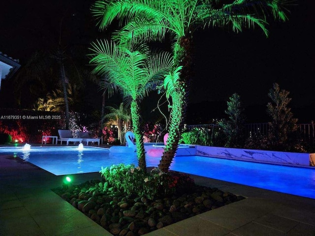 pool at twilight featuring a water slide