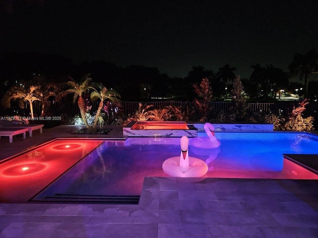 pool at night with a patio