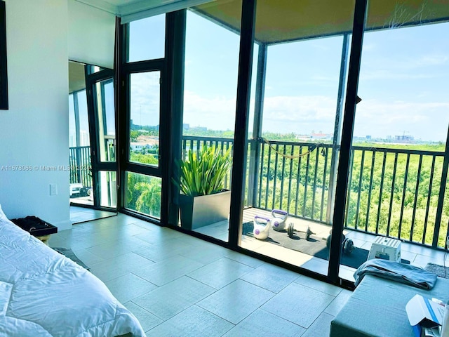 bedroom featuring multiple windows and floor to ceiling windows