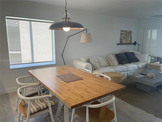 dining area with crown molding and hardwood / wood-style floors