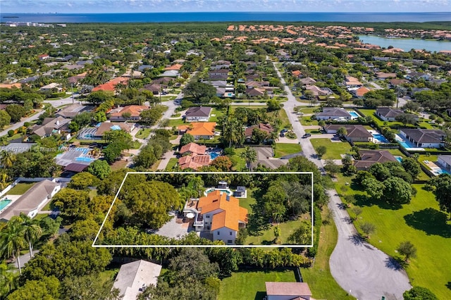 birds eye view of property with a water view