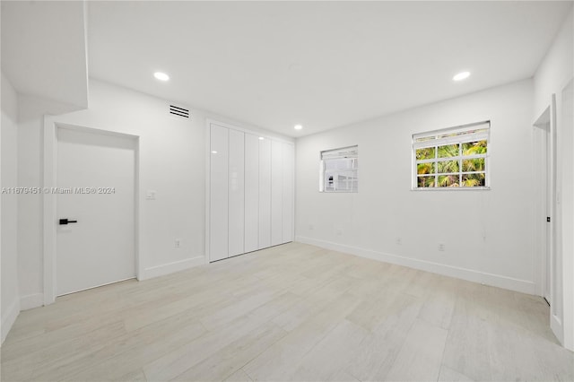 empty room with light hardwood / wood-style floors