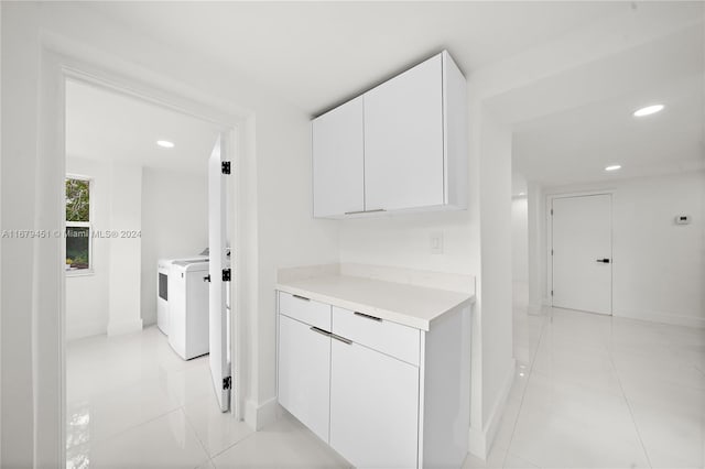 corridor featuring washing machine and clothes dryer and light tile patterned floors