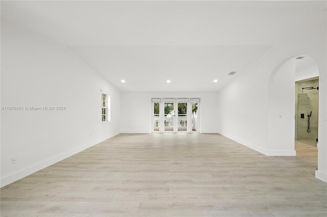 empty room with french doors and light wood-type flooring