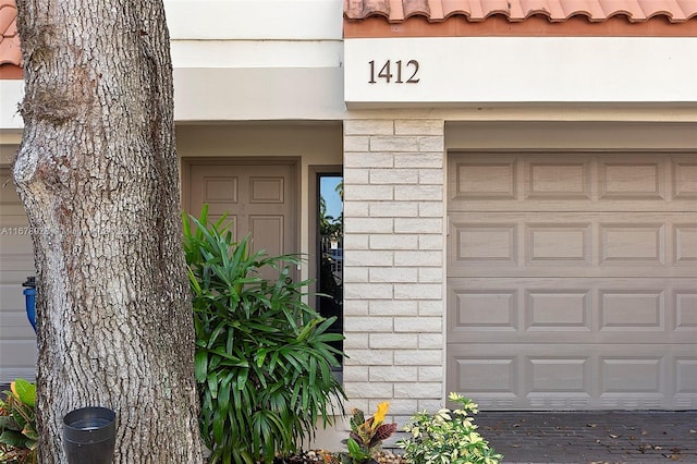 view of exterior entry featuring a garage