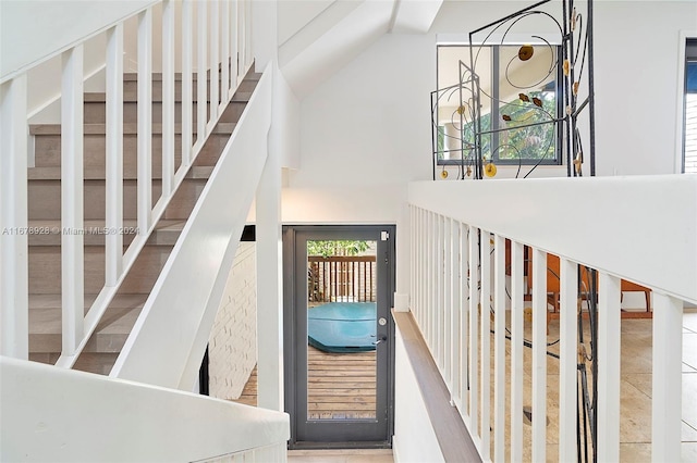 staircase with vaulted ceiling