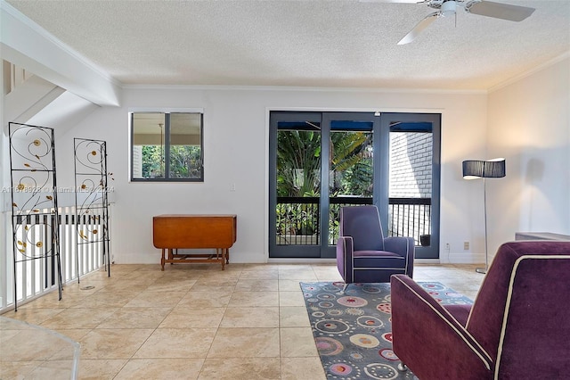 tiled living room with ceiling fan, ornamental molding, a textured ceiling, and plenty of natural light