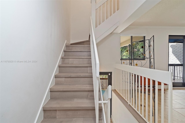 stairway with tile patterned floors