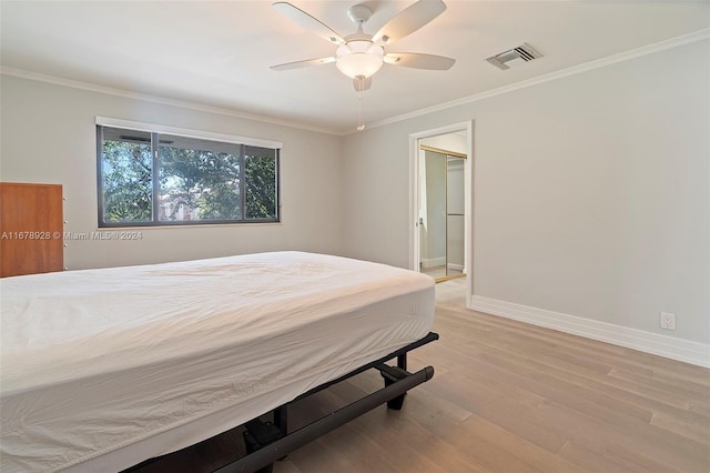 bedroom with a spacious closet, ceiling fan, ornamental molding, and light wood-type flooring