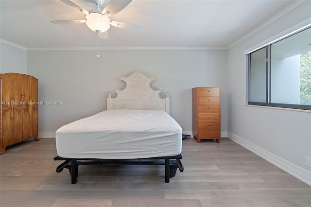 bedroom featuring ornamental molding, light hardwood / wood-style flooring, and ceiling fan