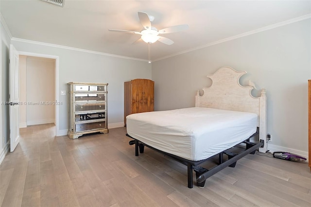 bedroom with ceiling fan, crown molding, and wood-type flooring