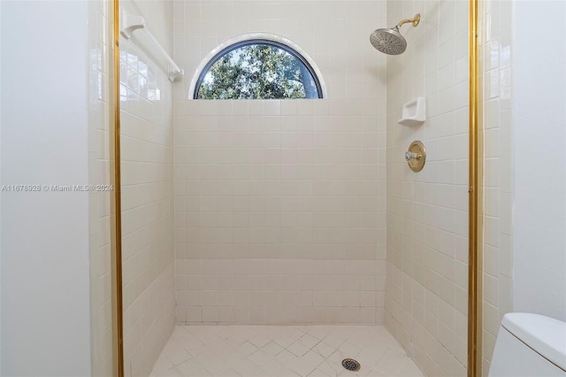 bathroom featuring toilet and tiled shower