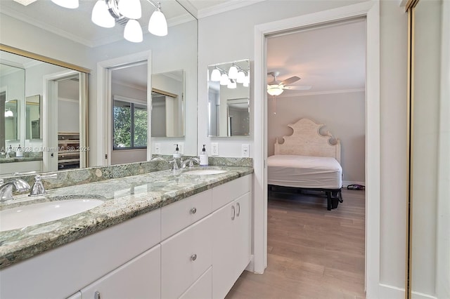 bathroom with vanity, crown molding, wood-type flooring, and ceiling fan