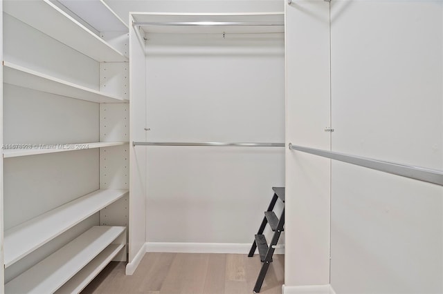 walk in closet featuring light hardwood / wood-style flooring