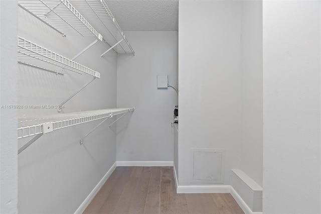 spacious closet featuring hardwood / wood-style flooring