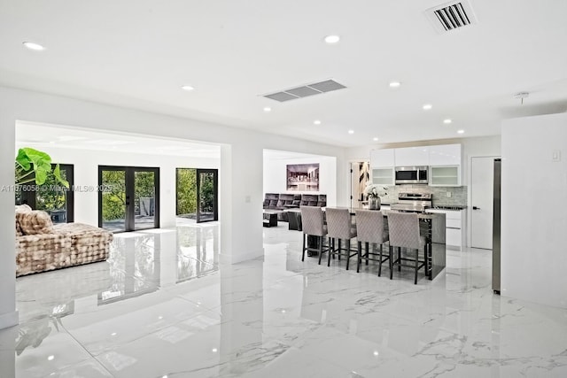 2340 NE 194th St, Miami, FL 33180 - living room with recessed lighting, french doors, and light marble finish floors