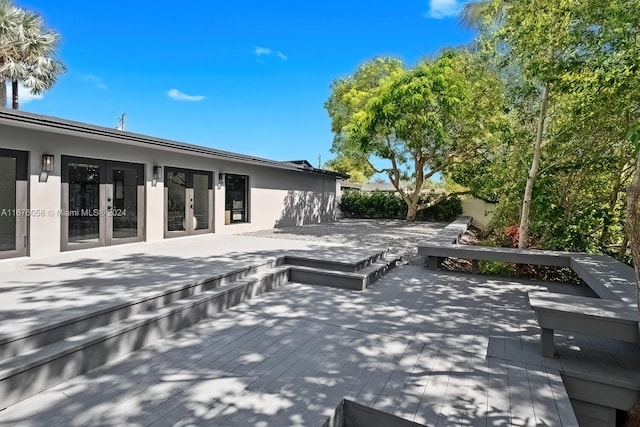 view of patio with a wooden deck and french doors