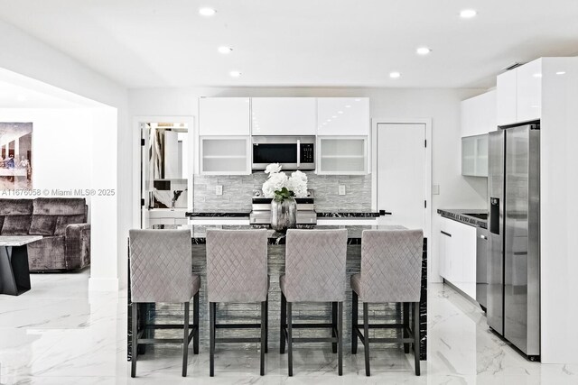 2340 NE 194th St, Miami, FL 33180 - kitchen featuring appliances with stainless steel finishes, modern cabinets, tasteful backsplash, white cabinets, and recessed lighting