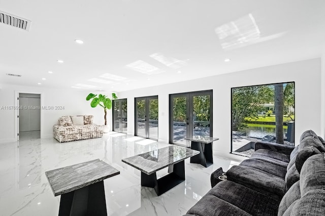 living room featuring a water view and french doors