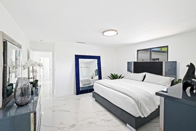 2340 NE 194th St, Miami, FL 33180 - bedroom featuring light marble finish floors and baseboards