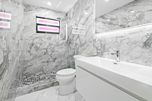 bathroom with vanity, toilet, tiled shower, and tile walls