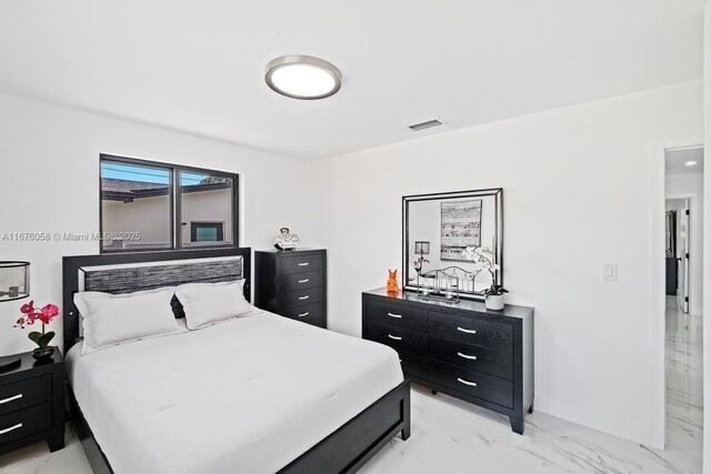 2340 NE 194th St, Miami, FL 33180 - bedroom with light marble finish floors and baseboards