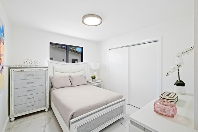 2340 NE 194th St, Miami, FL 33180 - bedroom featuring light marble finish floors and a closet