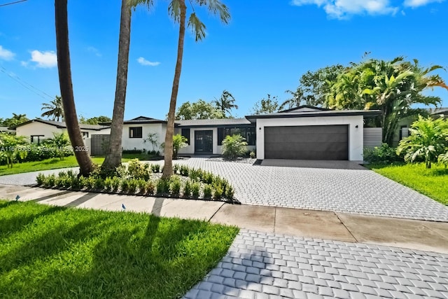 2340 NE 194th St, Miami, FL 33180 - view of front of home featuring a garage, stucco siding, and decorative driveway
