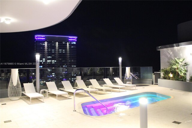1000 Brickell Plz Unit 3112, Miami, FL 33131 - pool at twilight featuring a patio and a swimming pool