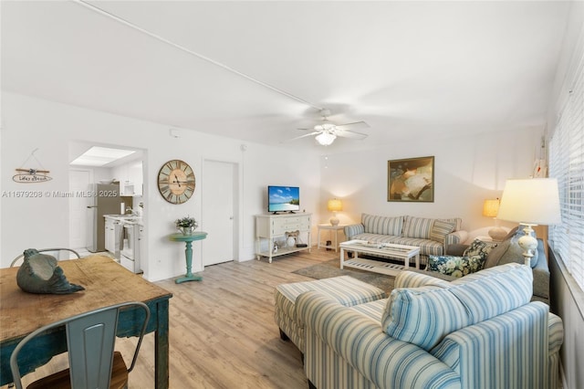 living room with ceiling fan, light wood-type flooring, and a wealth of natural light