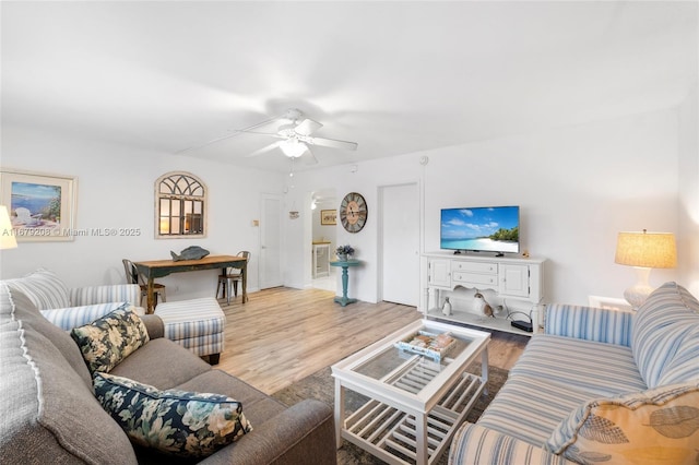 living room with light wood-type flooring and ceiling fan