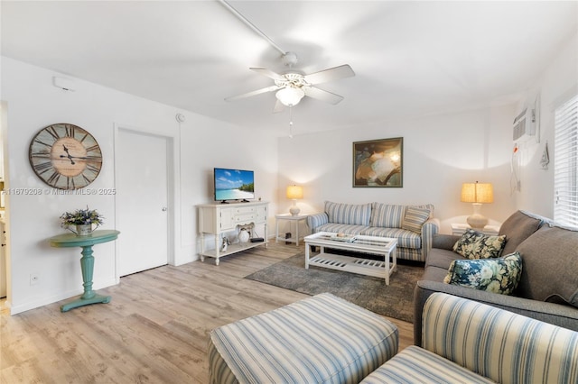 living room featuring ceiling fan and light hardwood / wood-style flooring