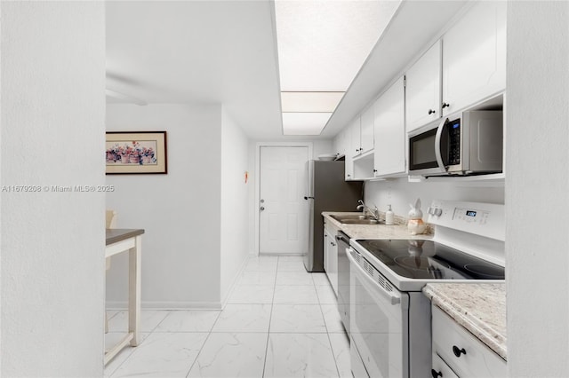 kitchen featuring sink, white cabinets, and appliances with stainless steel finishes