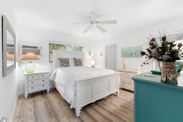 bedroom with a wall mounted air conditioner, light hardwood / wood-style floors, and ceiling fan