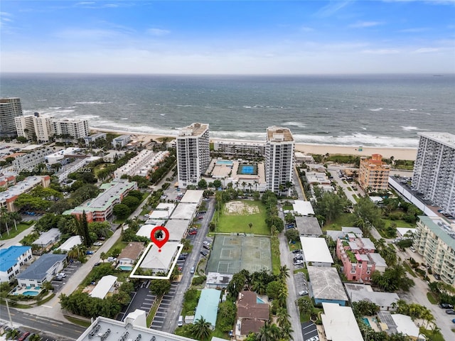 birds eye view of property featuring a beach view and a water view