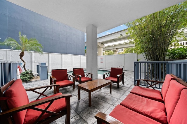 view of patio with a fenced in pool and an outdoor living space