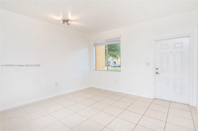 unfurnished room featuring light tile patterned floors