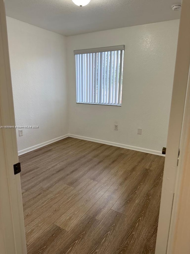 spare room with hardwood / wood-style floors