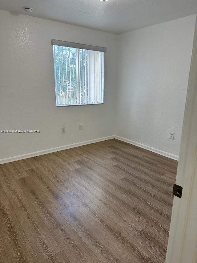 spare room featuring hardwood / wood-style floors