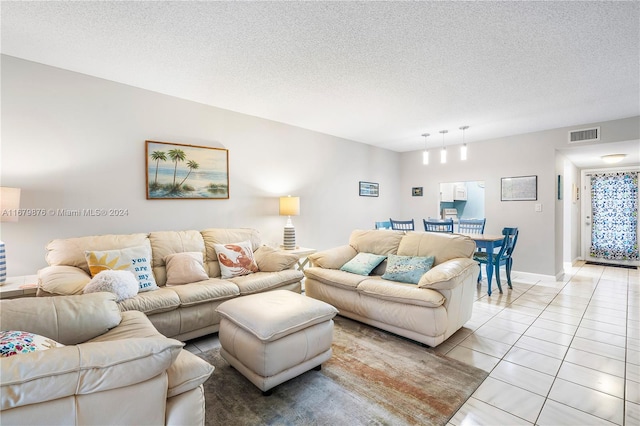 tiled living room with a textured ceiling