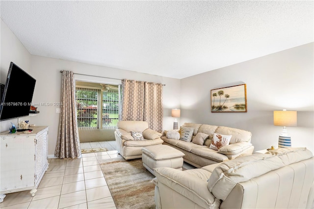 living room with a textured ceiling and light tile patterned flooring