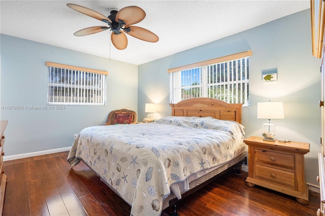 bedroom featuring dark hardwood / wood-style flooring, a textured ceiling, and ceiling fan