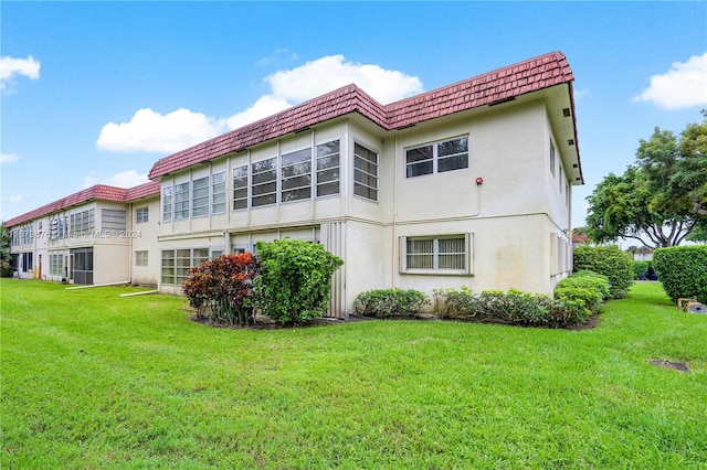 rear view of property with a yard