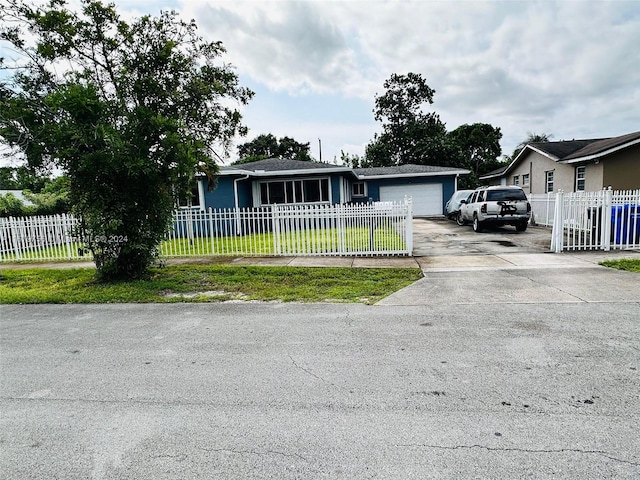 view of front of home featuring a front yard and a garage