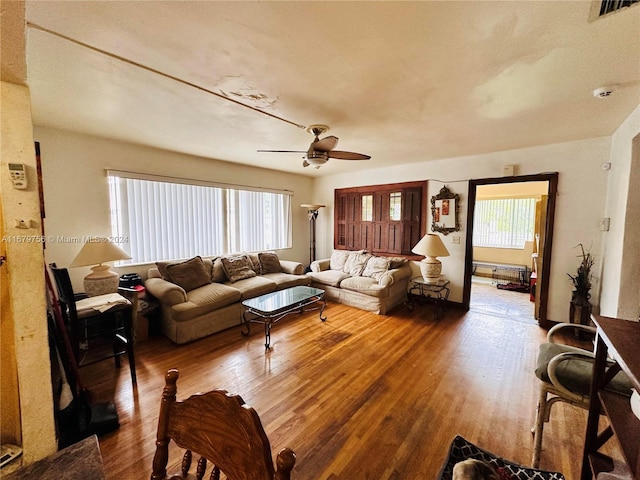 living room with hardwood / wood-style floors and ceiling fan