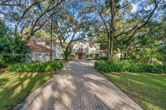 mediterranean / spanish home featuring a front lawn