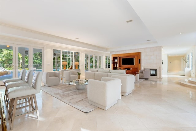 living room featuring french doors, plenty of natural light, and crown molding